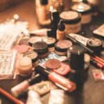 Various cosmetics and makeup products displayed on a vanity table. Ideal for beauty and fashion themes.